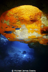 Diver in a volcanic cave by Michael James Sealey 